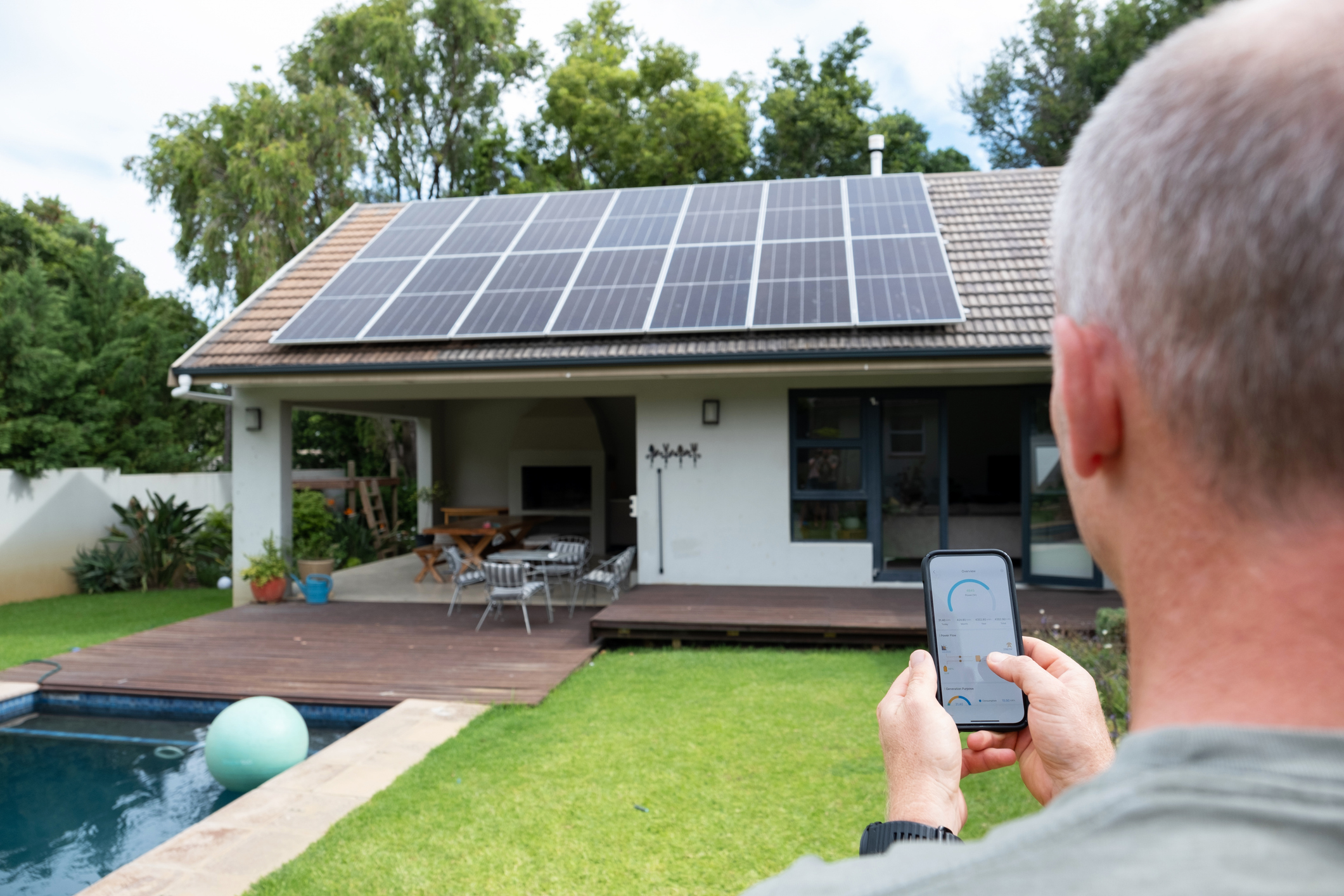 Man uses mobile app to control his solar power system.